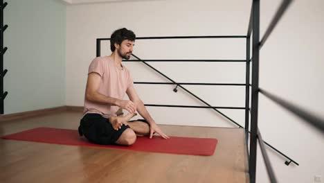 Man-stretching-at-home-on-yoga-mat