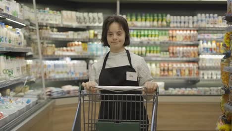 Filialmitarbeiter-Mit-Down-Syndrom-Schiebt-Einkaufswagen-In-Einem-örtlichen-Supermarkt