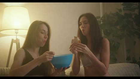 Young-woman-lesbian-couple-are-taking-sandwiches-and-bowl,-girl-feeding-her-girlfriend