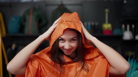 A-woman-trying-colorful-raincoat-at-the-sportive-store