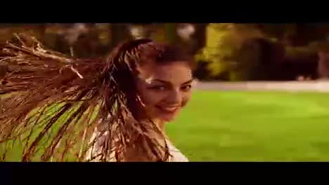 Long-hair-woman-with-dreads-running-in-park-and-turning-around-looking-in-camera.-Back-of-running-woman-in-slow-motion