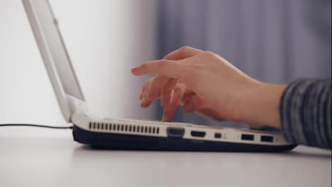 Close-Up-of-business-woman's-hands-typing-on-laptop-keyboard.-Side-view-of-female-hands-typing-on-a-laptop.-Slow-Motion-shot