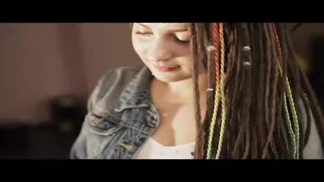 Close-Up-portrait-of-a-female-stylish-hairdresser-doing-dreads-for-a-young-smiling-woman-in-the-hair-salon.-Slow-Motion-shot