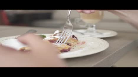 Unrecognizable-man-in-white-t-shirt-taking-desert-strudel-at-the-restaurant-using-fork-and-knife.-Slow-Motion-shot