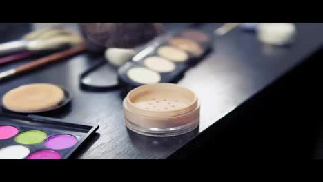 Professional-makeup-brushes-set-and-cosmetics-Close-Up.-Slow-Motion-shot