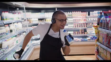 Glücklicher-Arbeiter-Im-Supermarkt,-Der-Zu-Den-Milchflaschen-Tanzt-Und-Singt