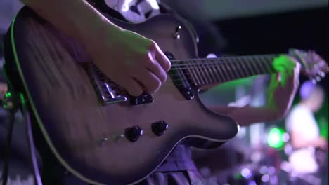 Close-Up-view-of-a-man-playing-electric-guitar-on-stage-at-the-concert.-Slow-Motion-shot
