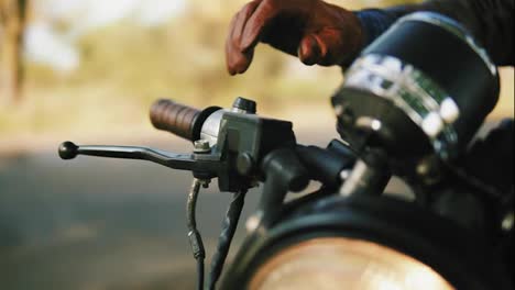 Close-Up-view-of-a-man's-hand-in-brown-leather-mitts-starting-the-engine.-Slow-Motion-shot