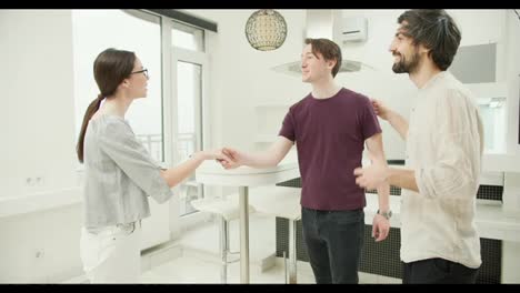 Gay-couple-shaking-hands-with-real-estate-agent-indoors