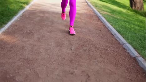 Runner-woman-running-in-the-park-exercising-outdoors,-close-up-on-feet.-Steadicam-stabilized-shot.-sports-women-training-in-the