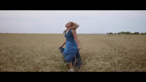 Beautiful-young-happy-girl-running-through-wheat-field.-Freedom-concept.-Turning-around-and-looking-to-the-camera.-Slow-Motion