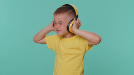 Happy-little-toddler-children-boy-listening-music-via-headphones,-dancing-disco,-fooling,-having-fun