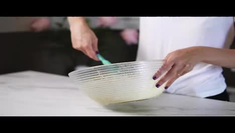 Close-Up-view-of-woman's-hands-mixing-ingredients-to-prepare-dough-in-the-the-bowl-using-whisk.-Home-cooking.-Slow-Motion-shot
