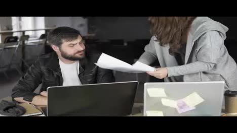 Businesswoman-throwing-papers-toward-her-colleague-showing-her-anger-at-the-office.-Slow-Motion