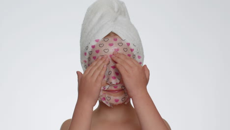 Child-girl-applying-cosmetic-moisturizing-face-mask,-teenager-facial-skin-care,-natural-cosmetics