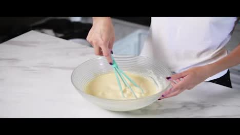 Unrecognizable-woman-mixing-ingredients-in-the-the-bowl-using-whisk.-Homemade-cooking.-Slow-Motion-shot