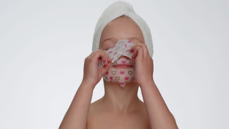 Child-girl-removing-cosmetic-moisturizing-face-mask,-teenager-facial-skin-care,-natural-cosmetics