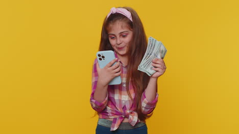 Smiling-happy-child-girl-use-smartphone-rejoicing-win,-receiving-money-dollar-cash-lottery-jackpot