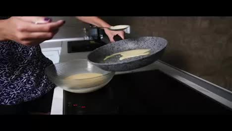 Female-hands-pouring-pancake-Mixed-in-a-frying-pan.-Homemade-food.-Slow-Motion-shot