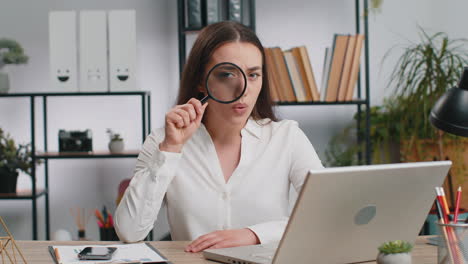 Business-woman-holding-magnifying-glass-near-face,-looking-with-big-zoomed-eye,-searching,-analysing