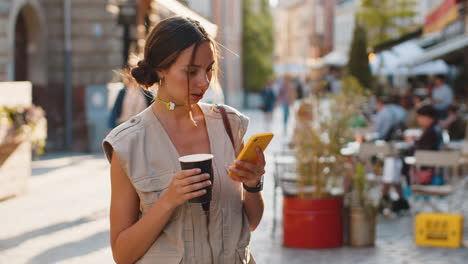 Tourist-traveler-woman-girl-using-looking-smartphone-search-a-way-on-map-in-mobile-navigator-app