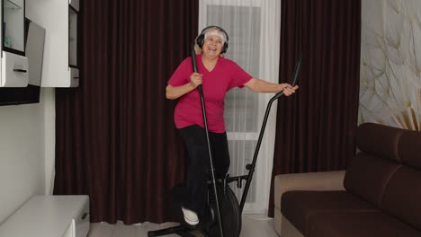 Senior-woman-using-orbitrek-with-fitness-exercises-in-room-at-home-during-coronavirus-lockdown