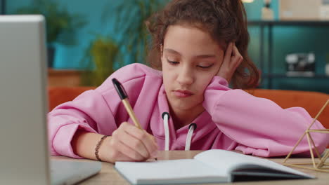 Preteen-school-girl-using-laptop-for-online-lesson,-doing-homework,-distance-learning-education
