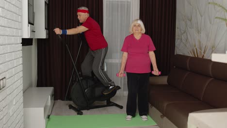 Senior-man-woman-doing-vitality-weight-lifting-sport-dumbbells-exercises-and-using-orbitrek-at-home