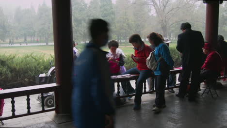 People-play-cards-in-a-gazebo-in-a-park-in-China