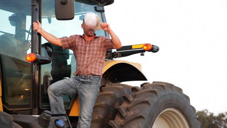 A-handsome-farmer-stands-aside-his-tractor-1