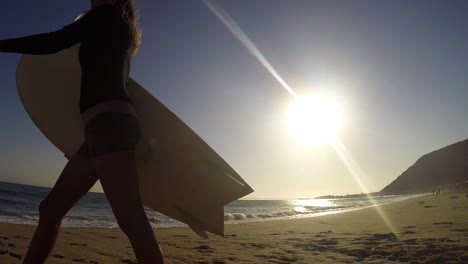 A-surfer-walks-across-the-sunrise-or-sunset