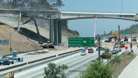 View-of-heavy-equipment-tearing-down-part-of-a-bridge-over-the-405-freeway-in-Los-Angles