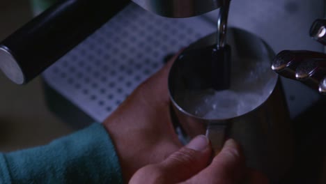 Closeup-of-milk-frothing-at-an-espresso-machine