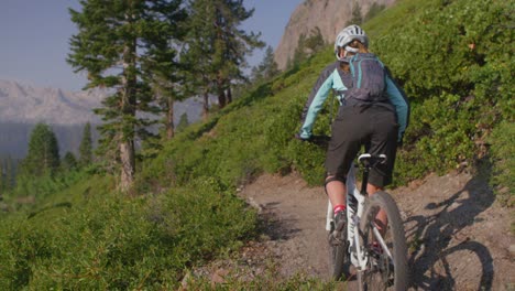 A-mountain-biker-rides-on-a-path-near-a-forest-1