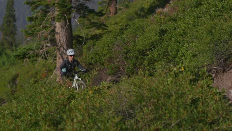 A-mountain-biker-rides-on-a-path-near-a-forest-2
