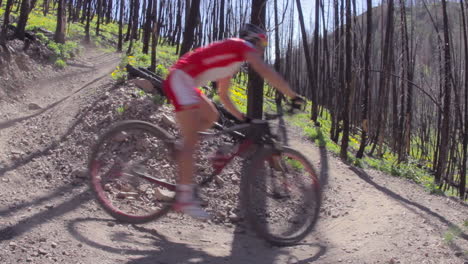 A-man-rides-a-mountain-bike-fast-through-a-forest