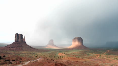 A-rainbow-fades-in-the-sunlight-following-a-storm-over-Monument-Valley-Utah