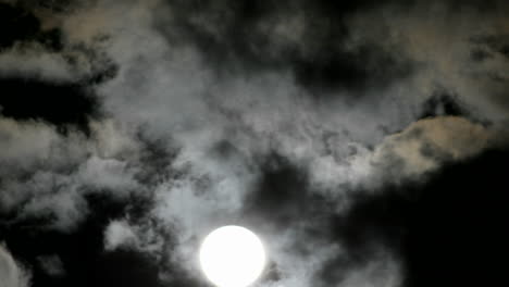 A-bright-full-moon-rises-above-swiftly-moving-clouds-in-the-night-sky-1