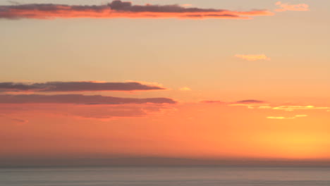 Vivid-orange-clouds-darken-to-black-as-the-sun-slips-below-the-horizon