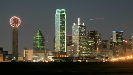 Slow-pan-of-city-lights-illuminating-the-Dallas-skyline-at-night