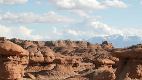Slow-pan-of-white-clouds-floating-in-a-blue-sky-over-Goblin-Valley-State-Park
