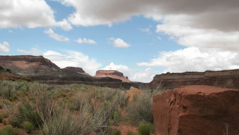 Slow-rightpan-of-a-timelapse-shot-showing-clouds-passing-over-Utah's-Mexican-Hat-Canyon