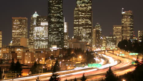 Accelerated-traffic-blurs-into-streaks-of-light-before-an-illuminated-Seattle-skyline