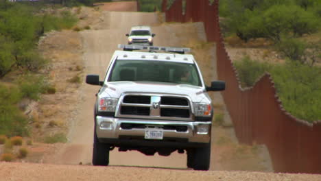 Border-patrol-vehicles-move-along-the-US-Mexico-border