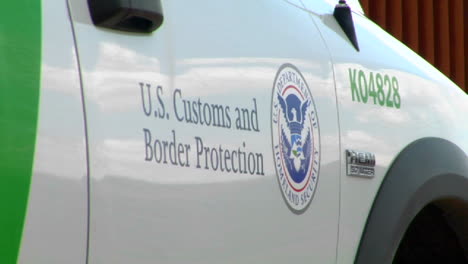 A-close-up-of-the-US-Customs-and-Border-Protection-sign-on-the-side-of-a-patrol-vehicle