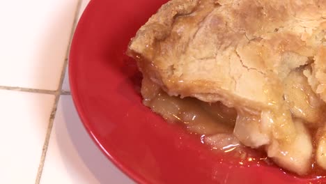 A-Fresh-Baked-Slice-Of-Apple-Pie-Is-Ready-To-Eat-On-A-Red-Plate