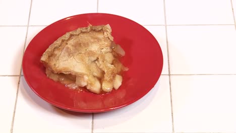 A-Fresh-Baked-Slice-Of-Apple-Pie-Steams-On-A-Red-Plate