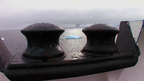 Artistic-shot-looking--through-tie-bars--to-see-ocean-below-with-icebergs-visible-
