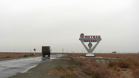 An-old-Soviet-era-cargo-truck-passes-on-a-road-into-Muynaq-in-Kazakhstan-or-Uzbekistan