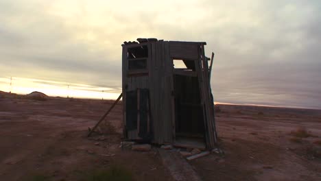 An-outhouse-stands-in-the-middle-of-a-desert